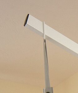 grey sling hanging on white pole